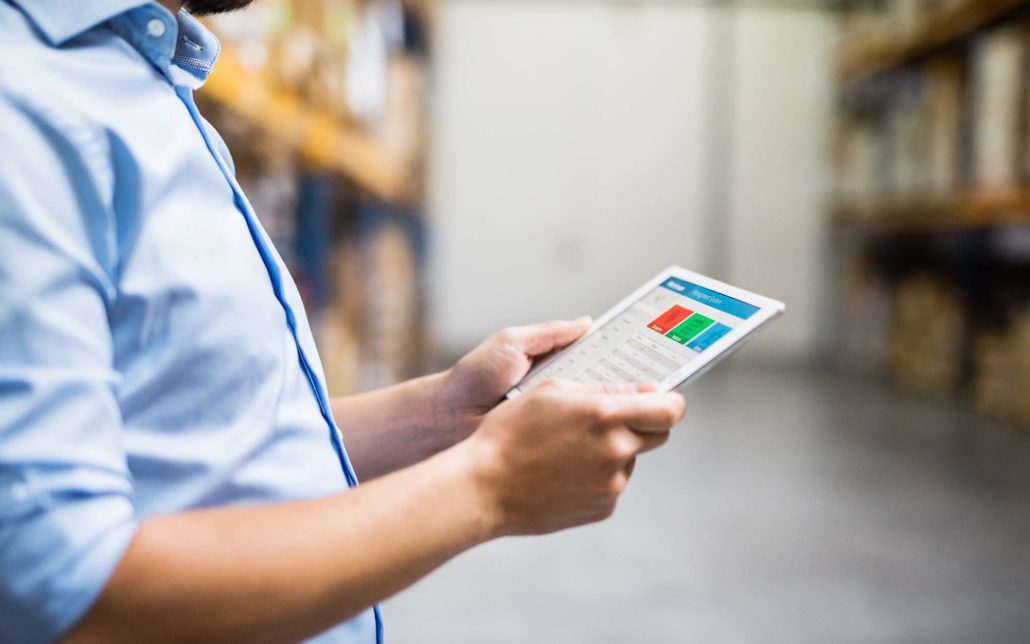 Warehouse worker looking over logistics on a tablet