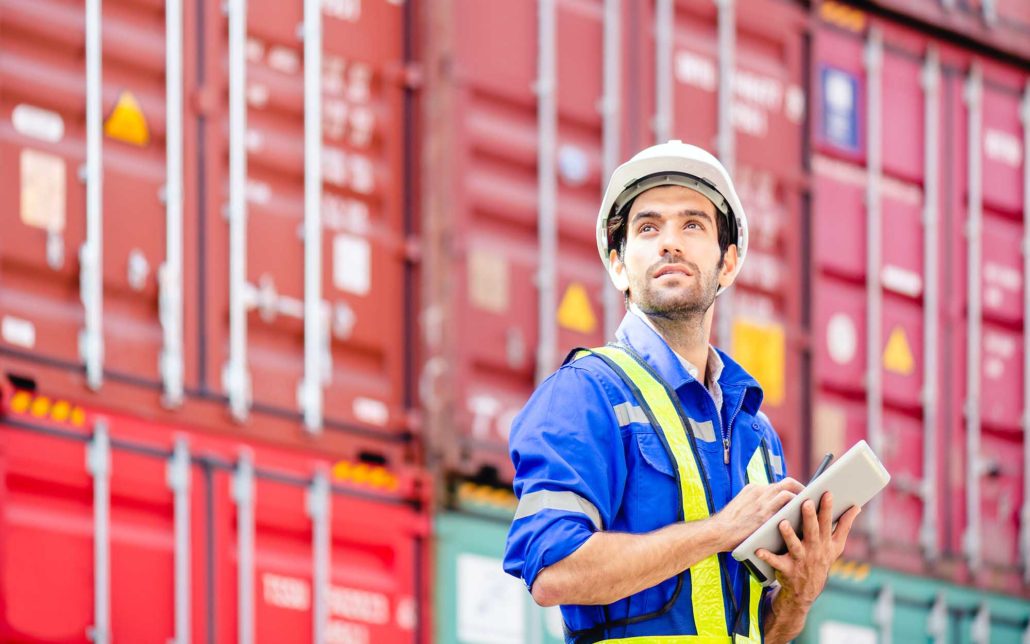Dock worker using tablet for freight audit and payment